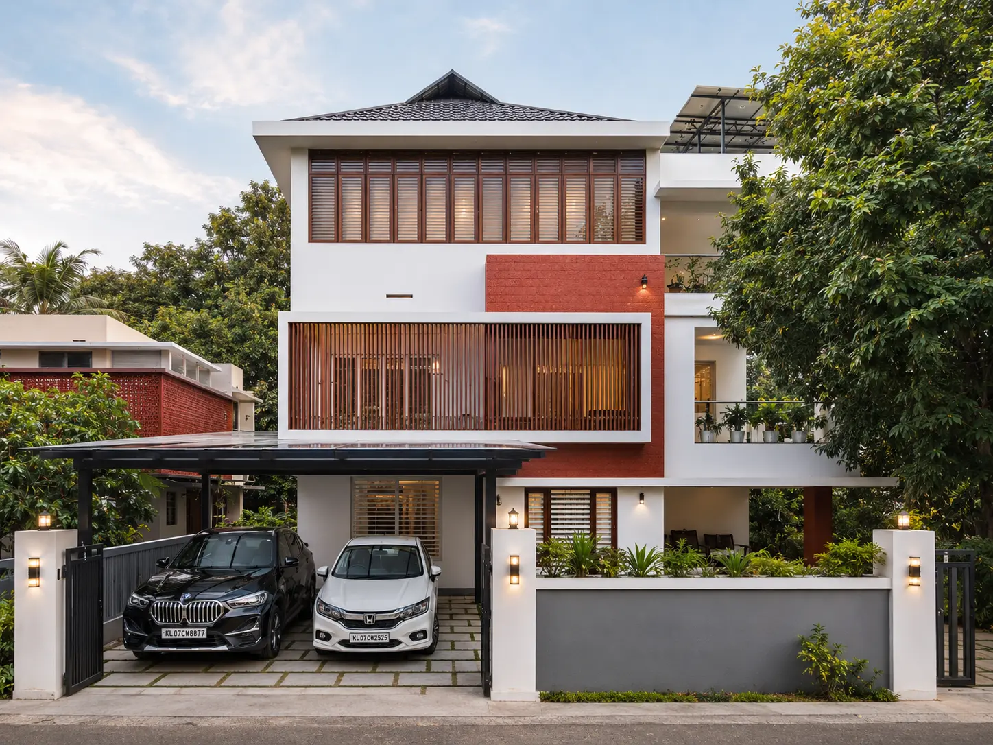 Contemporary home with red brick accent and twin carport — Exterior work by Alpha Design Studio