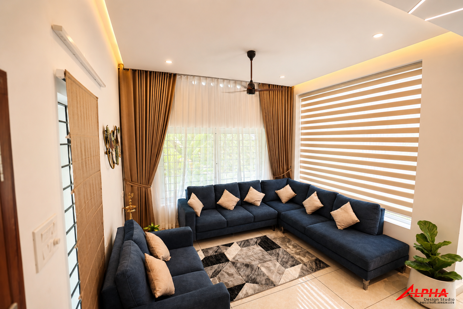 Living room with navy sectional and layered drapes — Interior work by Alpha Design Studio
