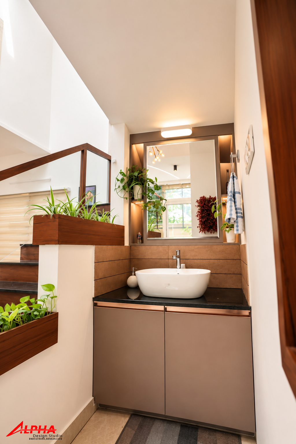 Washbasin nook with planters beside the staircase — Interior work by Alpha Design Studio