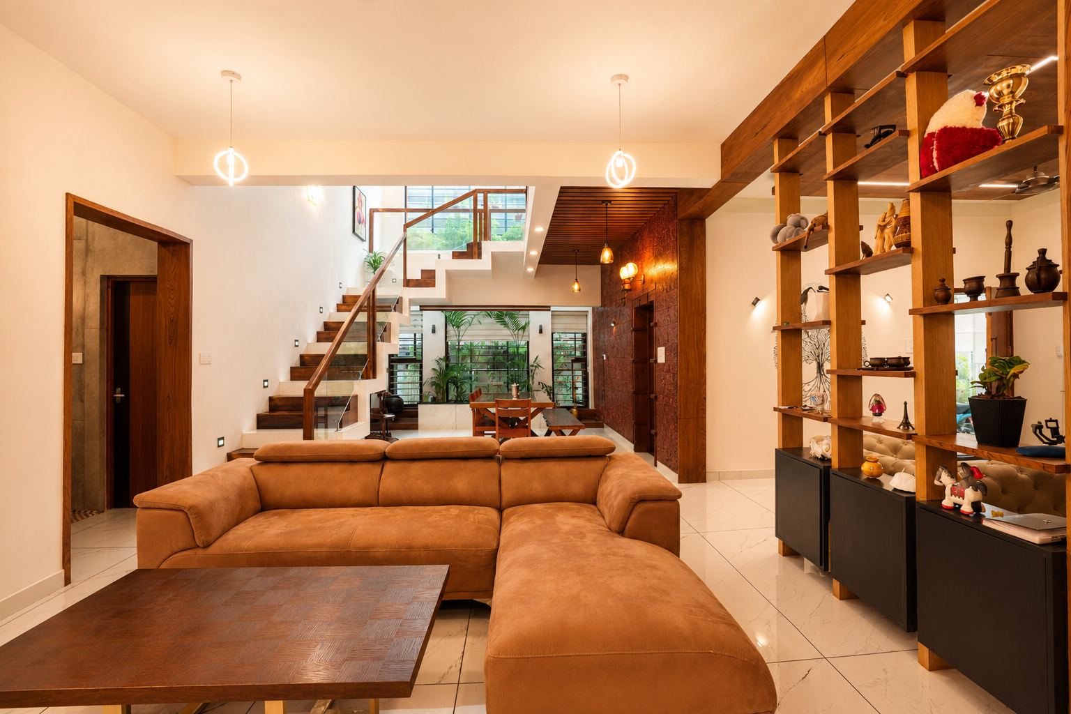 Living hall with tan sectional and teak display shelving — Interior work by Alpha Design Studio