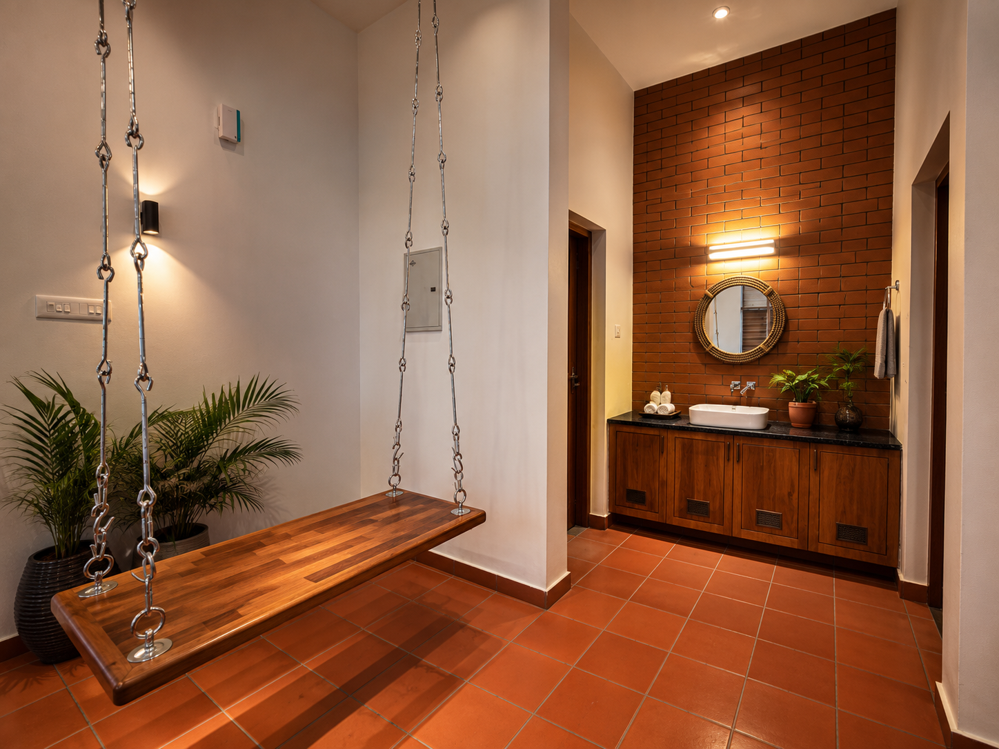 Timber swing seat beside a brick-clad washbasin — Interior work by Alpha Design Studio