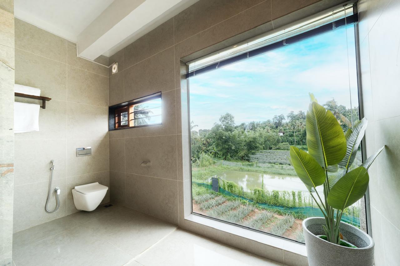 Bathroom framed by a picture window over the paddy fields — Interior work by Alpha Design Studio