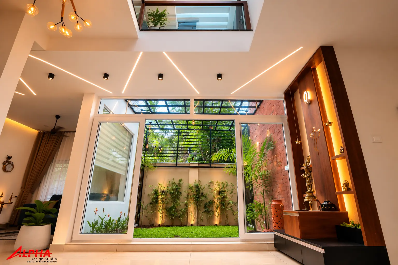 Double-height living hall with lit prayer niche — Interior work by Alpha Design Studio